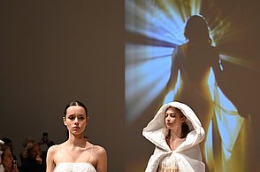 Foto von zwei Models die helle Kleidung tragen, die aus sanften Decken besteht