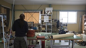 Foto einer Person die an Stoffen arbeitet