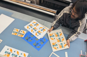 Foto von drei Personen die Bilder ausschneiden